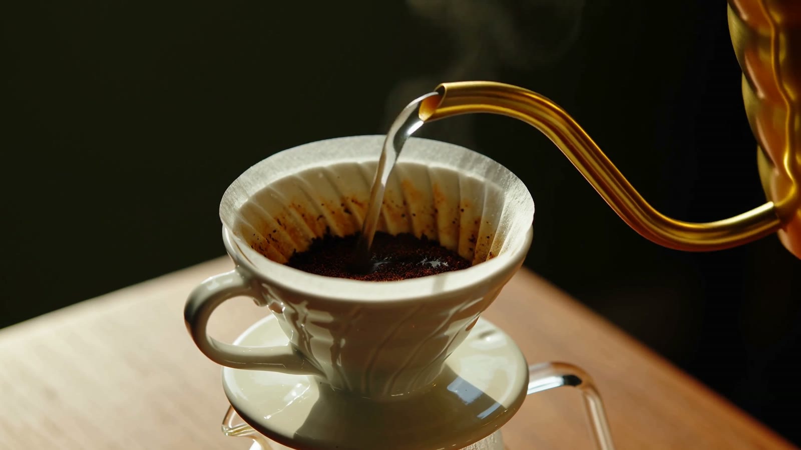 A slow pour-over coffee blooming in a ceramic dripper